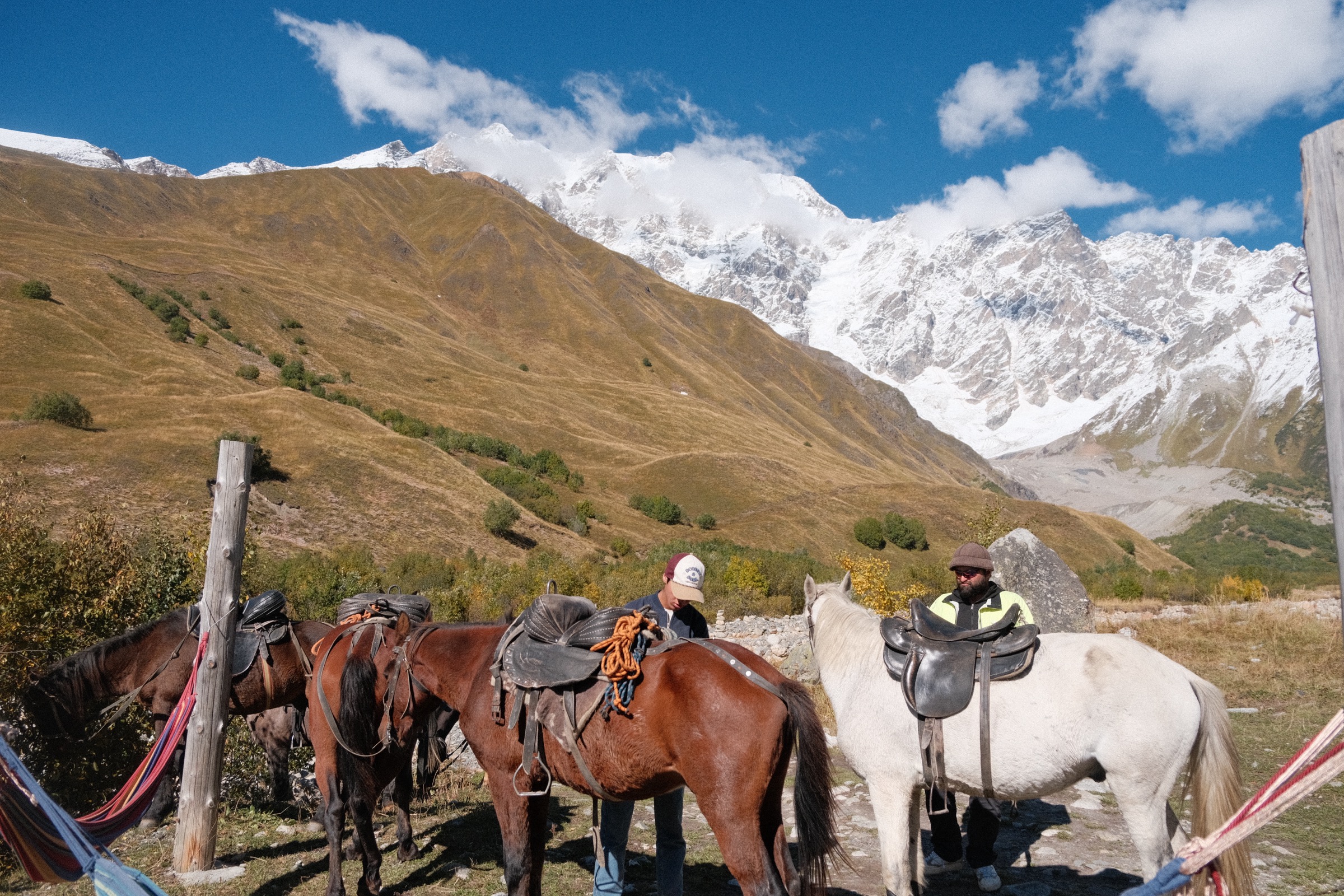 Group ride through alpine meadow above the village